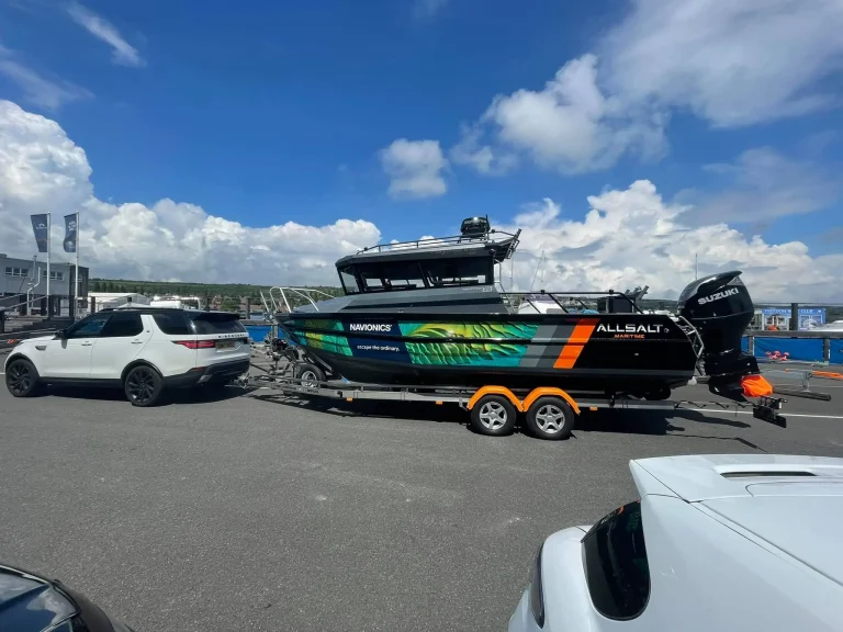 Green wrapped plate aluminium boat on a trailer