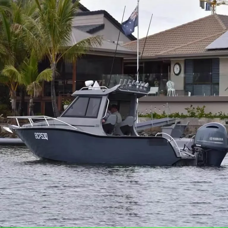 Grey plate aluminium cabin boat parked at a house