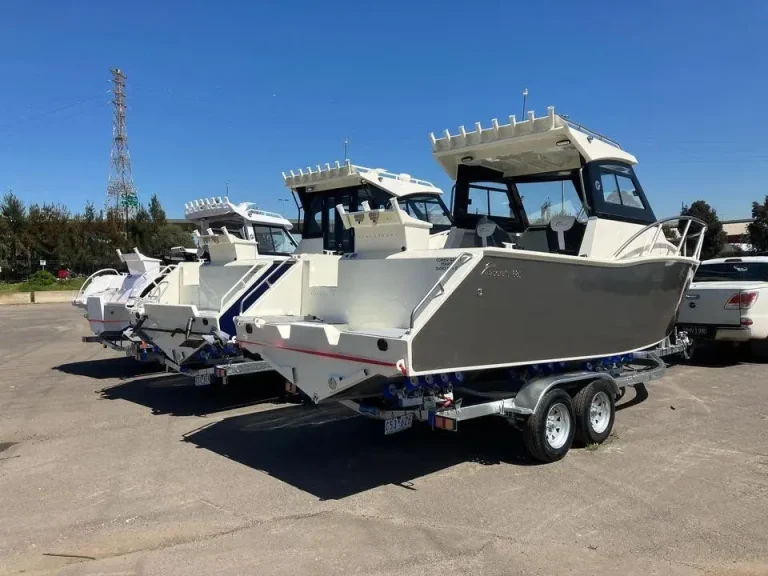 Grey plate aluminium hardtop boat on a tandem trailer