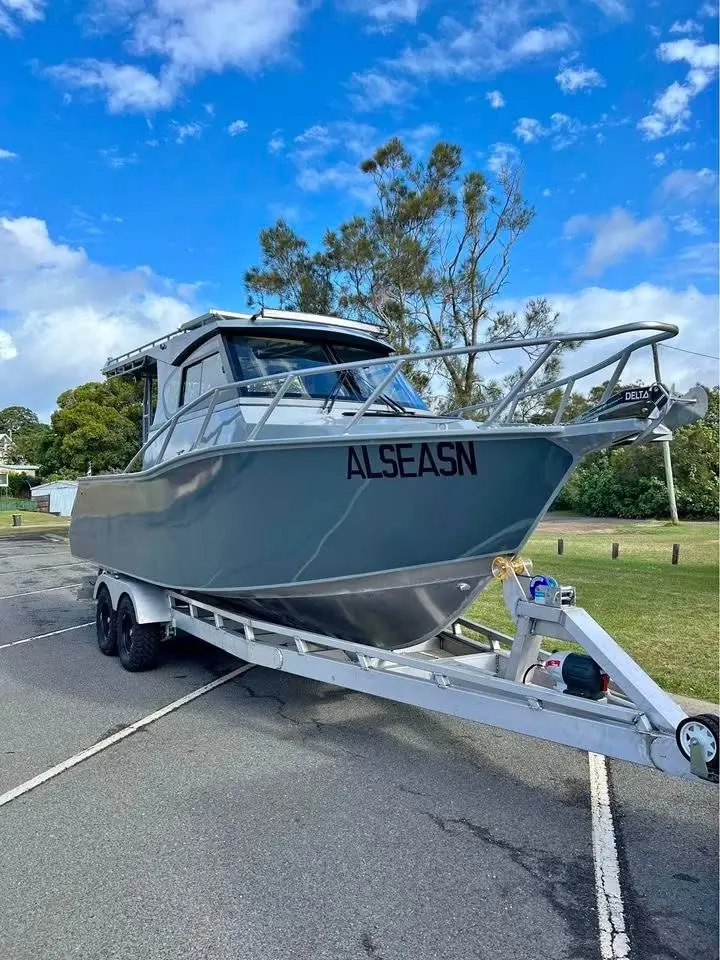 Grey plate aluminium hardtop boat on a trailer