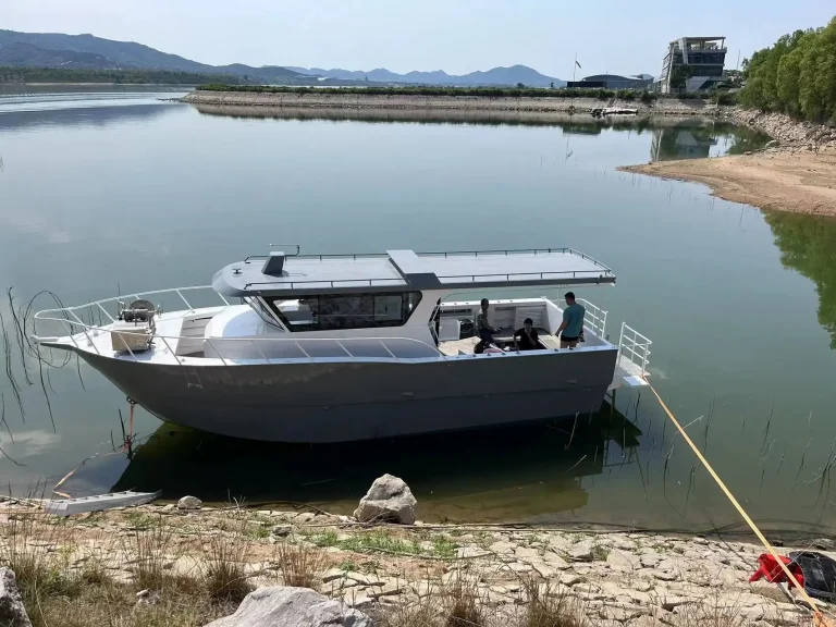 Grey plate aluminium work boat moored at the bank