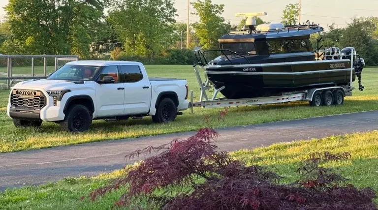 Hardtop plate aluminium boat on a trailer on a driveway