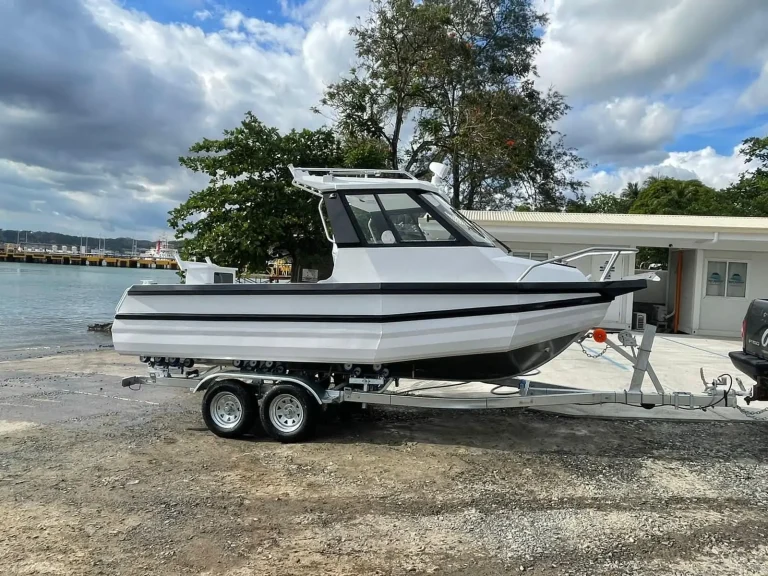 Hardtop plate aluminium fishing boat on a tandem trailer