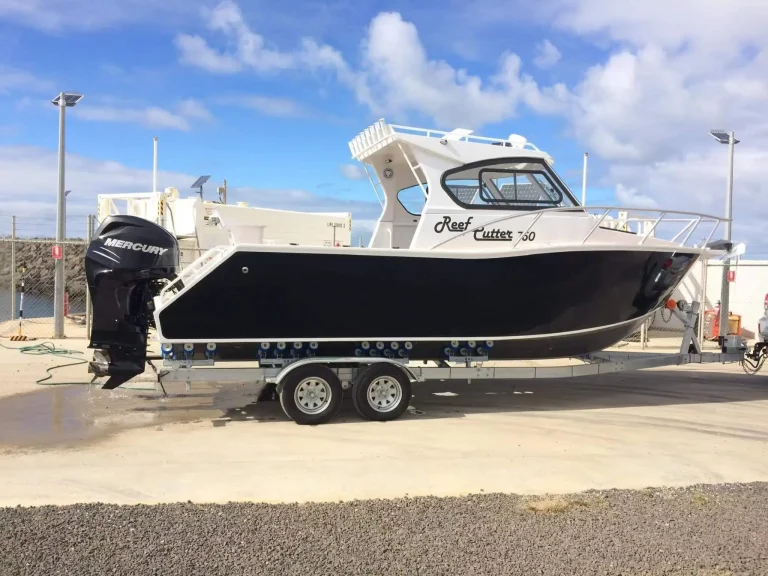 Hardtop plate aluminium fishing boat on a trailer at the boat ramp