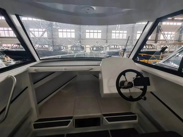 Helm and dash under a hardtop looking forward