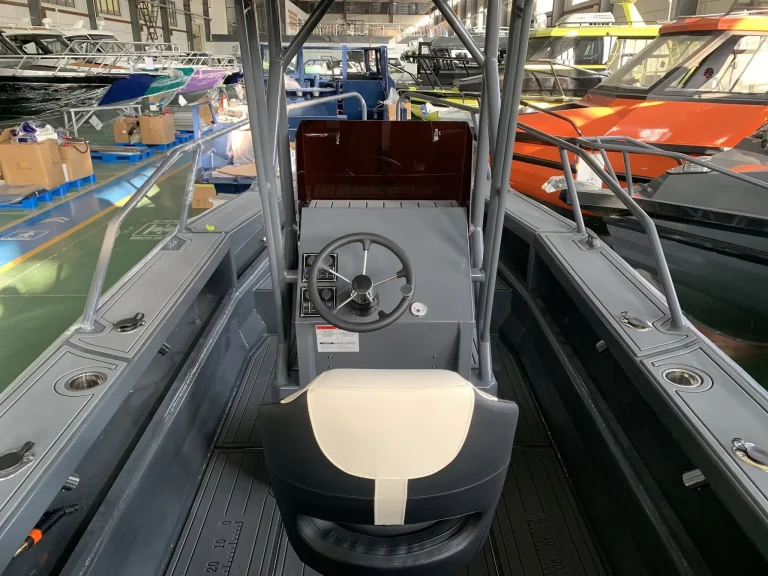 Helm seat and console in a bare aluminium boat