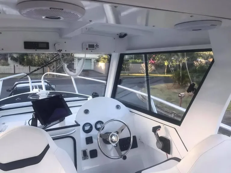 Helm station under a hardtop looking out over the bow