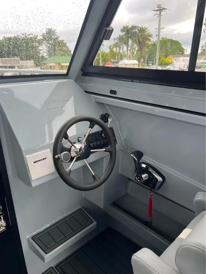 Helm wheel and dash inside a plate aluminium cabin