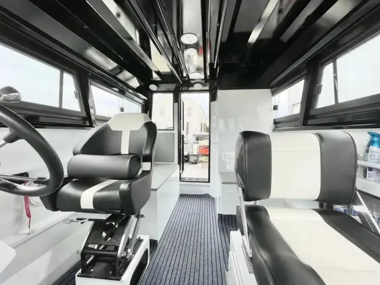Helm wheel and dash inside a plate aluminium cabin