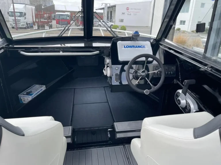 Helm with Lowrance display and grey upholstery