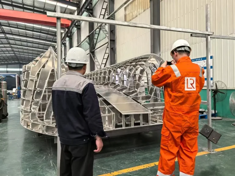 Inspectors reviewing an aluminium hull frame