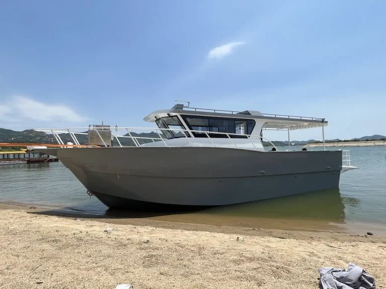 Landing craft with bow ramp resting on the sand