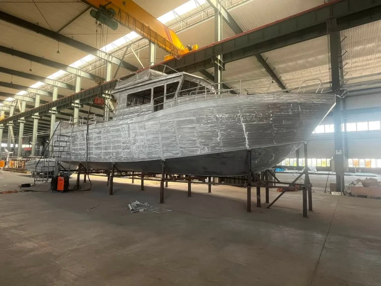 Long bare aluminium hull under construction
