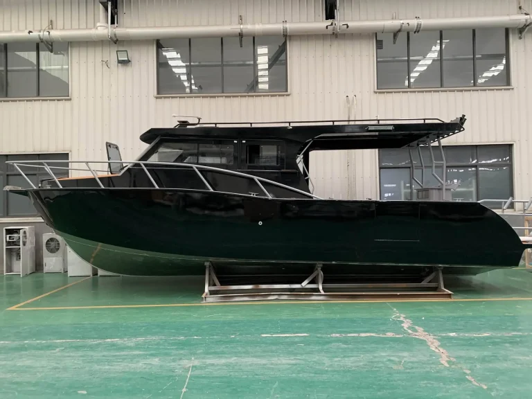 Long black plate aluminium cruiser on the factory floor