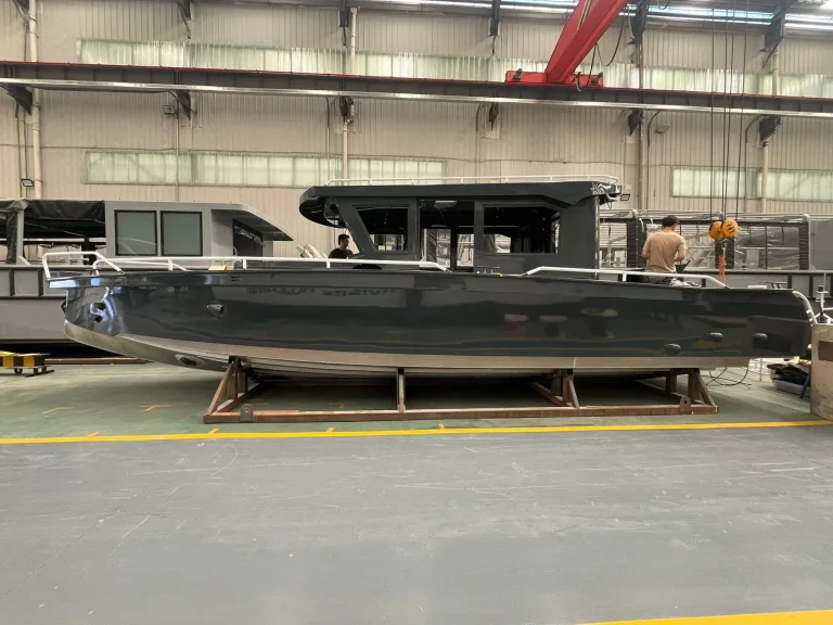 Long dark plate aluminium hull in the factory