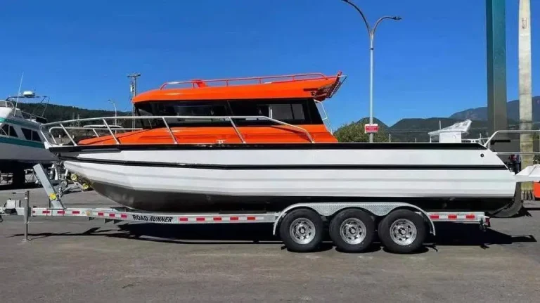 Long plate aluminium passenger boat on a trailer