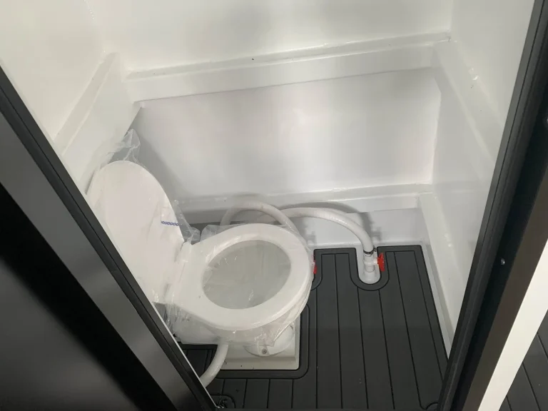 Marine toilet compartment with teak look flooring