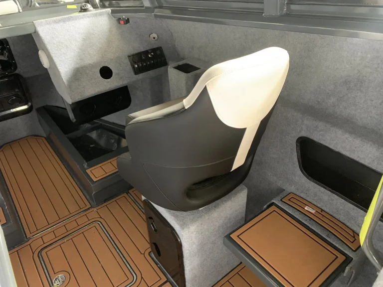 Moulded helm seat and step inside a cabin boat