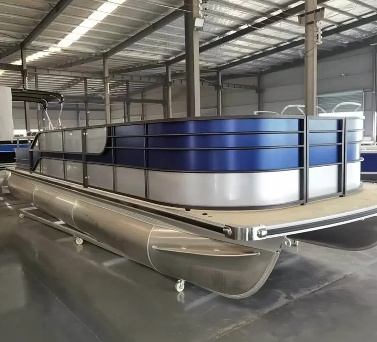 Navy and silver pontoon boat on the factory floor
