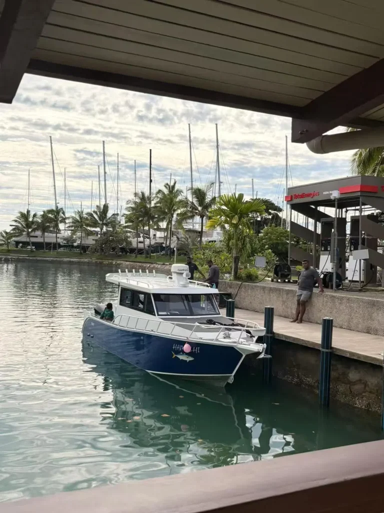 Navy plate aluminium cabin boat at a marina jetty