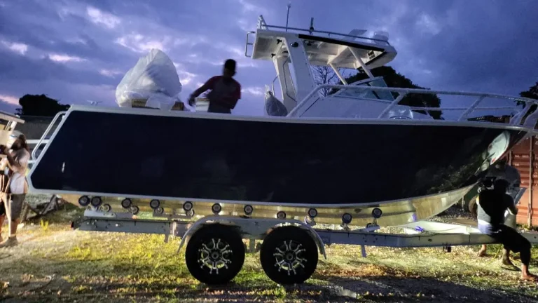 Navy plate aluminium hardtop boat on a trailer at dusk