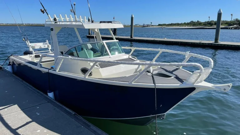 Navy plate aluminium sports cabin boat at a jetty