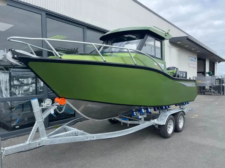 Olive green plate aluminium hardtop boat on a trailer