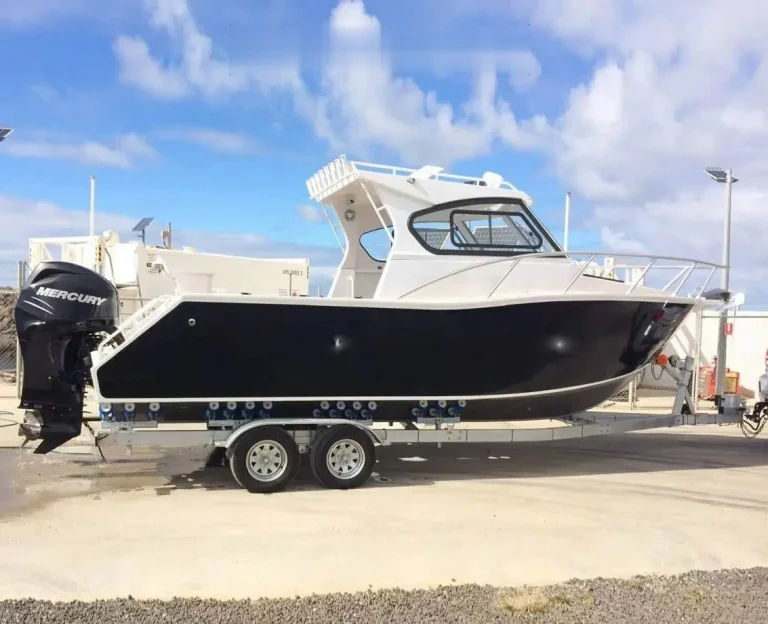 Open cabin plate aluminium fishing boat on a trailer