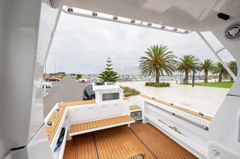 Open cockpit with teak look floor looking out to the marina
