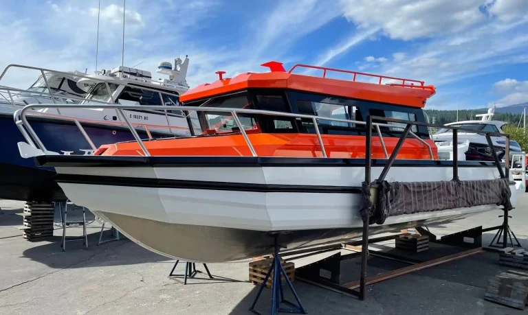Orange and white plate aluminium passenger boat on stands