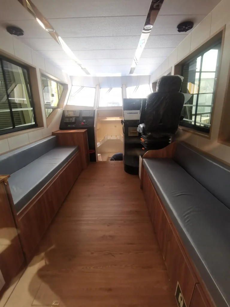Passenger cabin with bench seats and timber floor