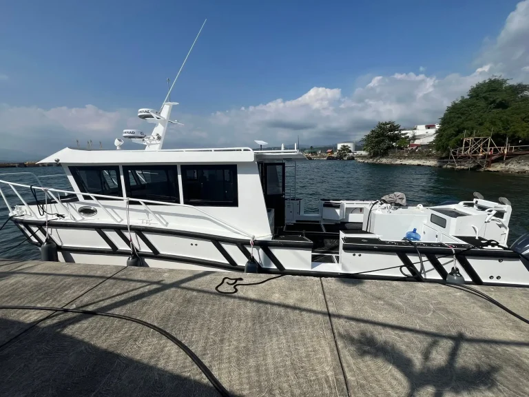 Passenger catamaran with upper deck on the water