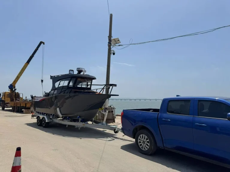 Patrol boat on a trailer behind a ute at the dock