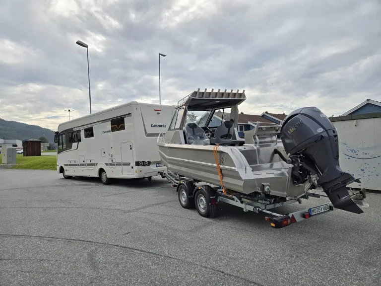 Plate aluminium boat and motorhome parked together