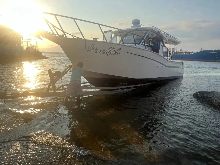 Plate aluminium boat at the shore at sunset