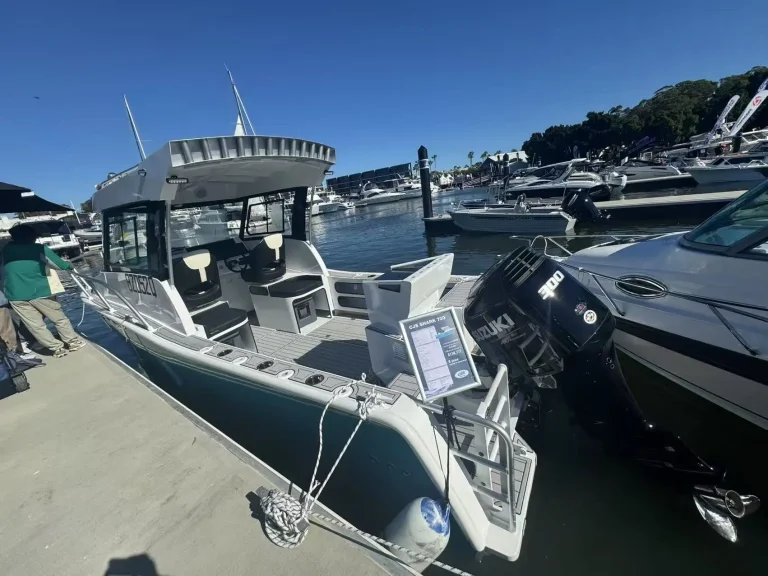 Plate aluminium boat berthed among cruisers