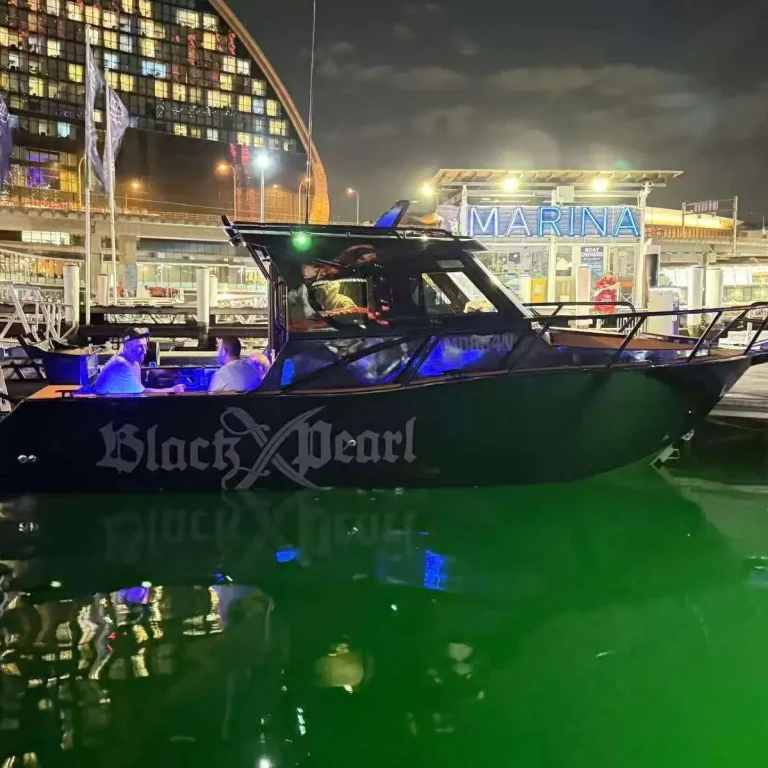 Plate aluminium boat lit up on a boat show stand at night
