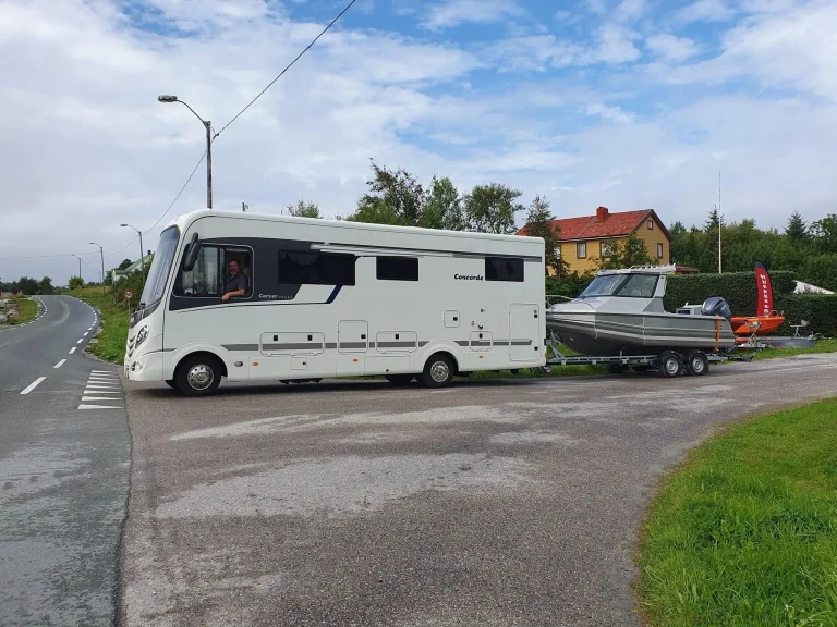 Plate aluminium boat on a trailer beside a motorhome
