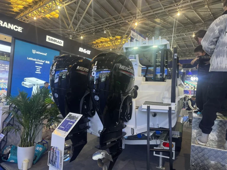 Plate aluminium boat with outboard on a show stand