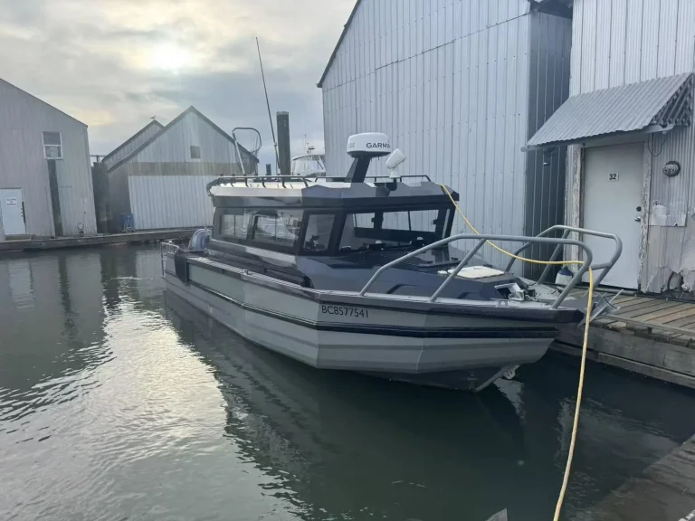 Plate aluminium cabin boat alongside a marina berth