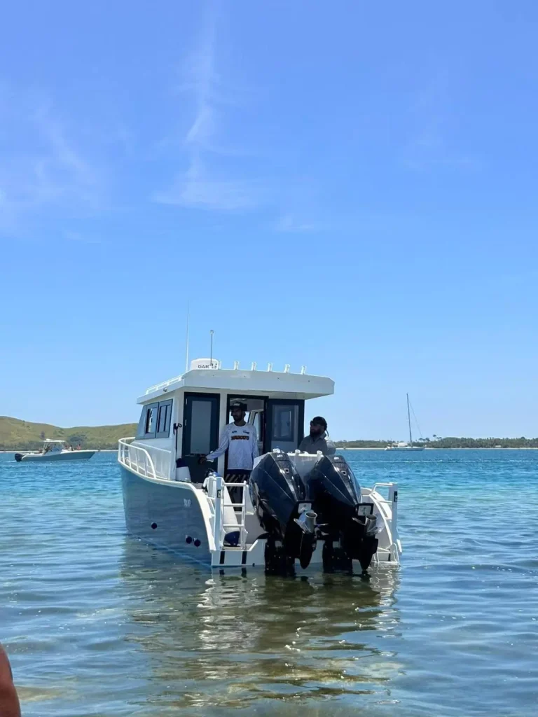 Plate aluminium cabin boat anchored in the shallows