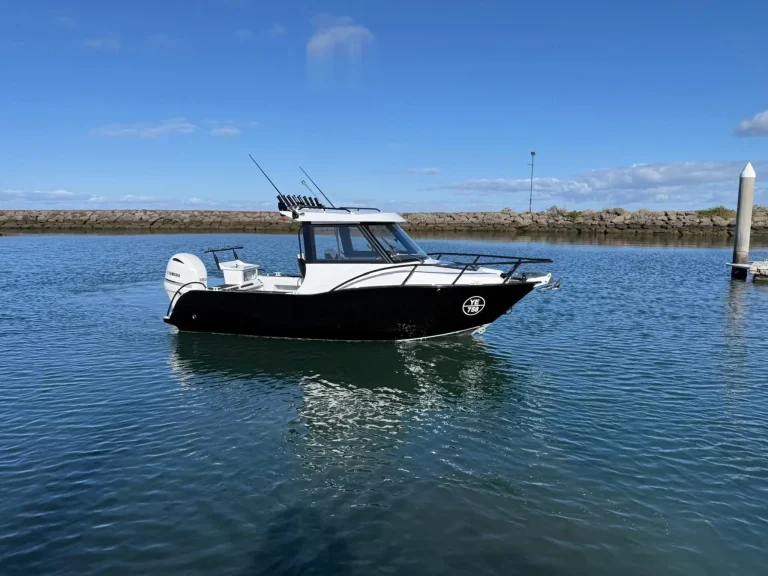 Plate aluminium cabin boat at anchor on flat water