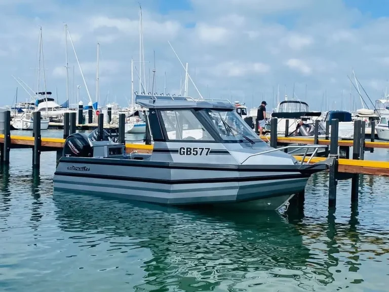 Plate aluminium cabin boat berthed at a floating pontoon