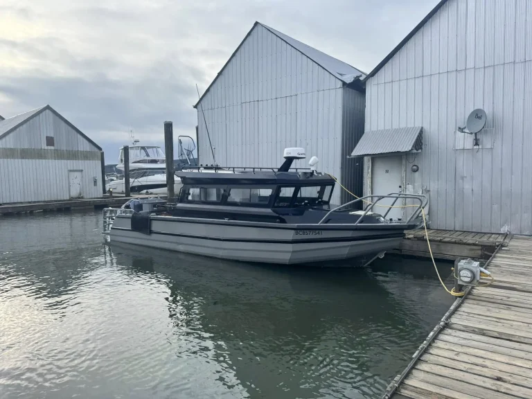 Plate aluminium cabin boat moored at a timber jetty