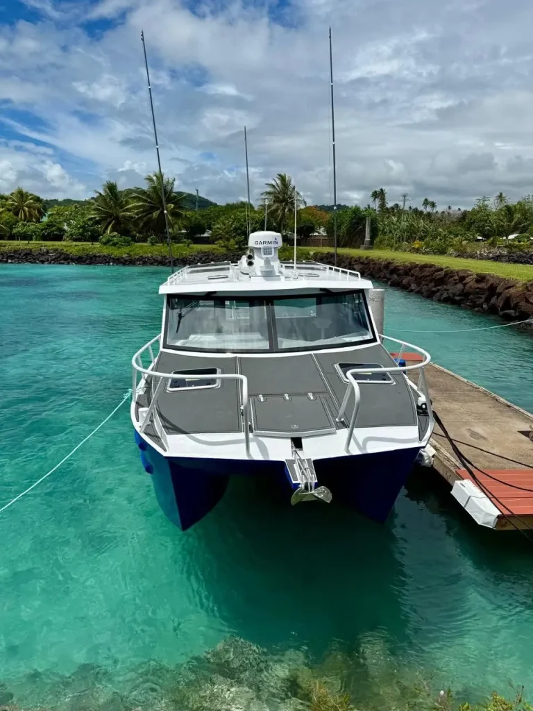 Plate aluminium cabin boat moored over clear water