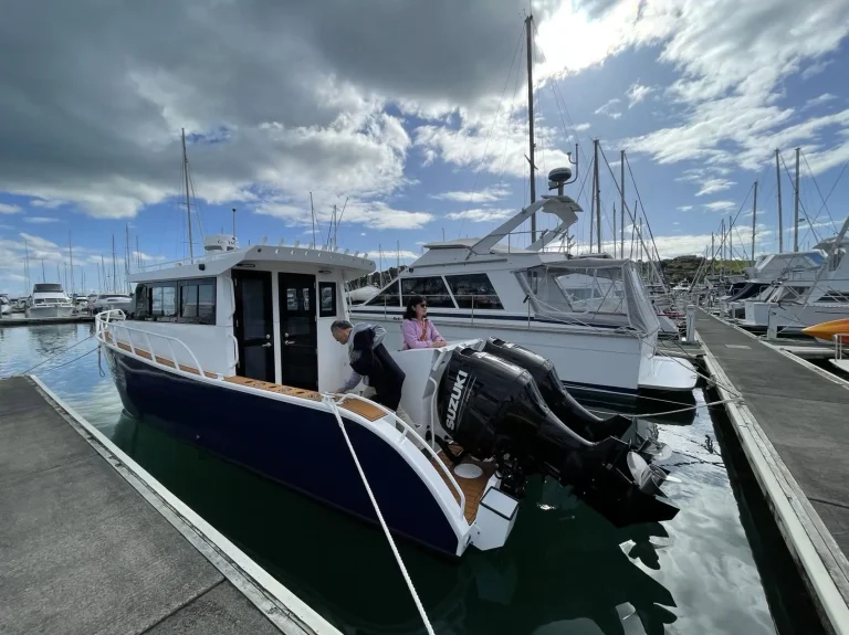 Plate aluminium cabin boat with twin outboards at the marina