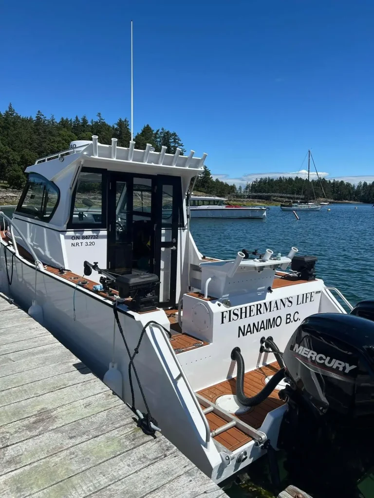 Plate aluminium charter boat with Mercury outboard at a wharf