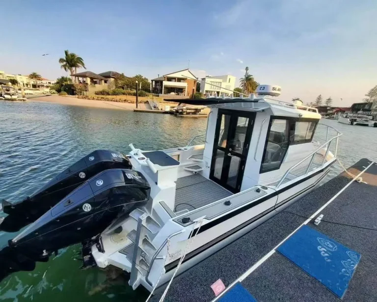 Plate aluminium cruiser with outboards at a canal berth