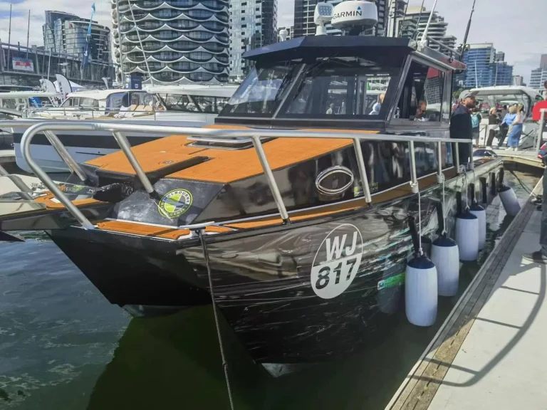 Plate aluminium dive boat berthed at a city wharf