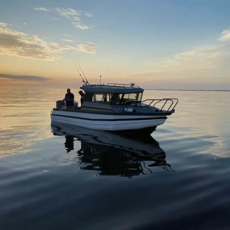 Plate aluminium fishing boat on still water at dusk